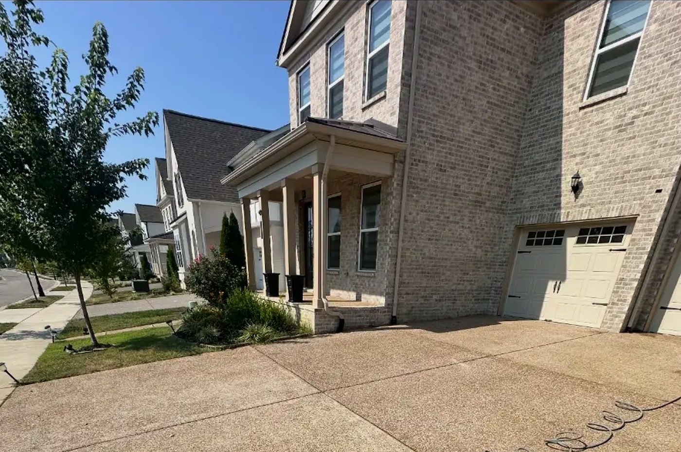 Faded exposed-aggregate driveway before sealing